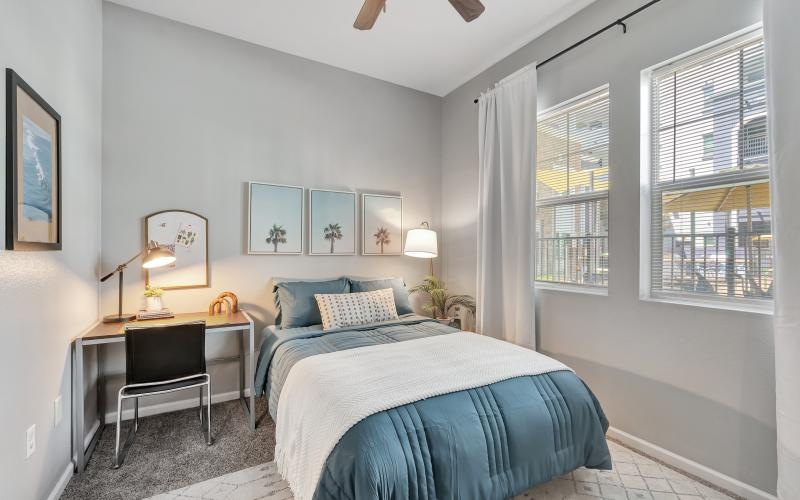 a bedroom with a bed and a desk