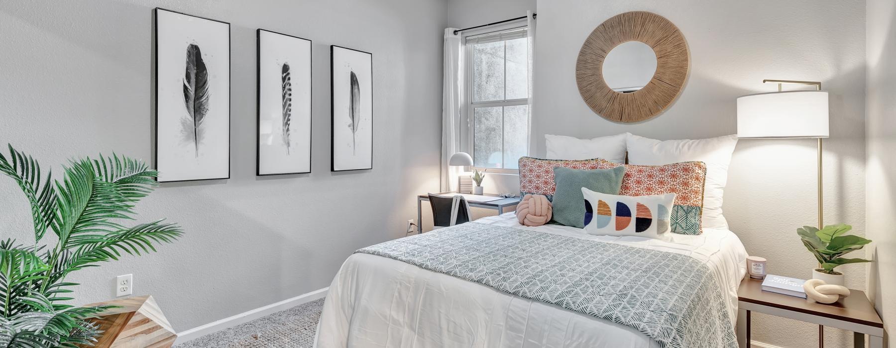 a bedroom with a bed and a mirror