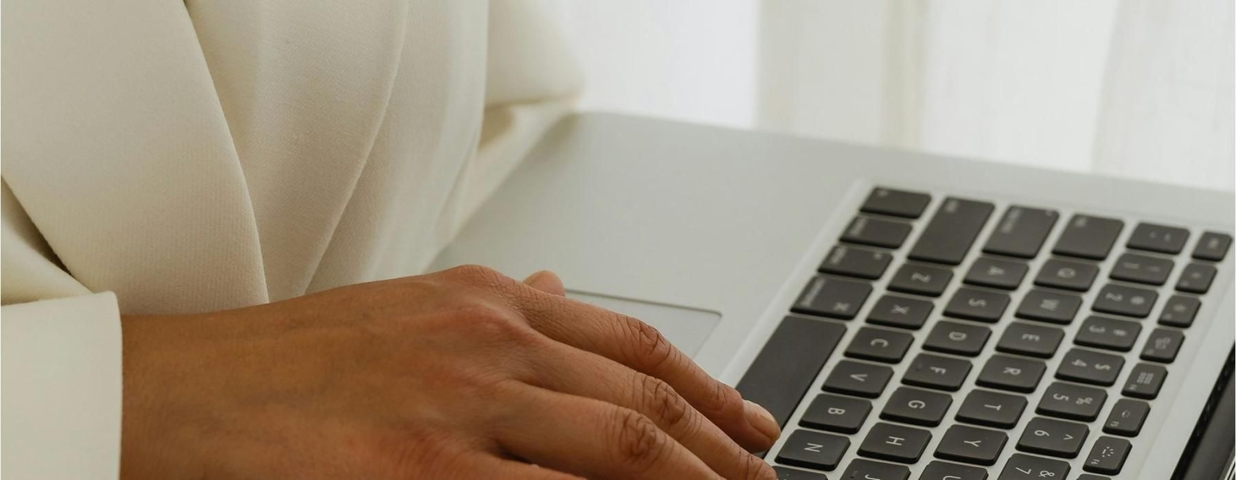 a person typing on a laptop