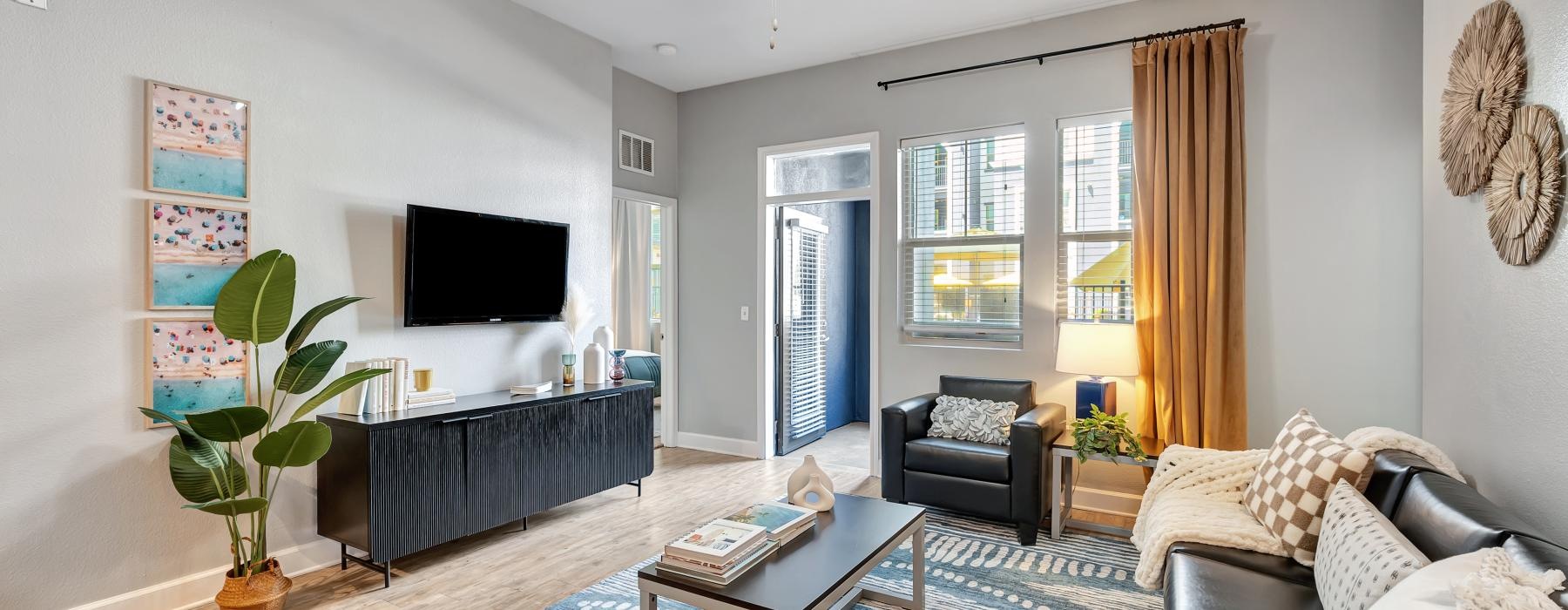 a living room with a tv and couches